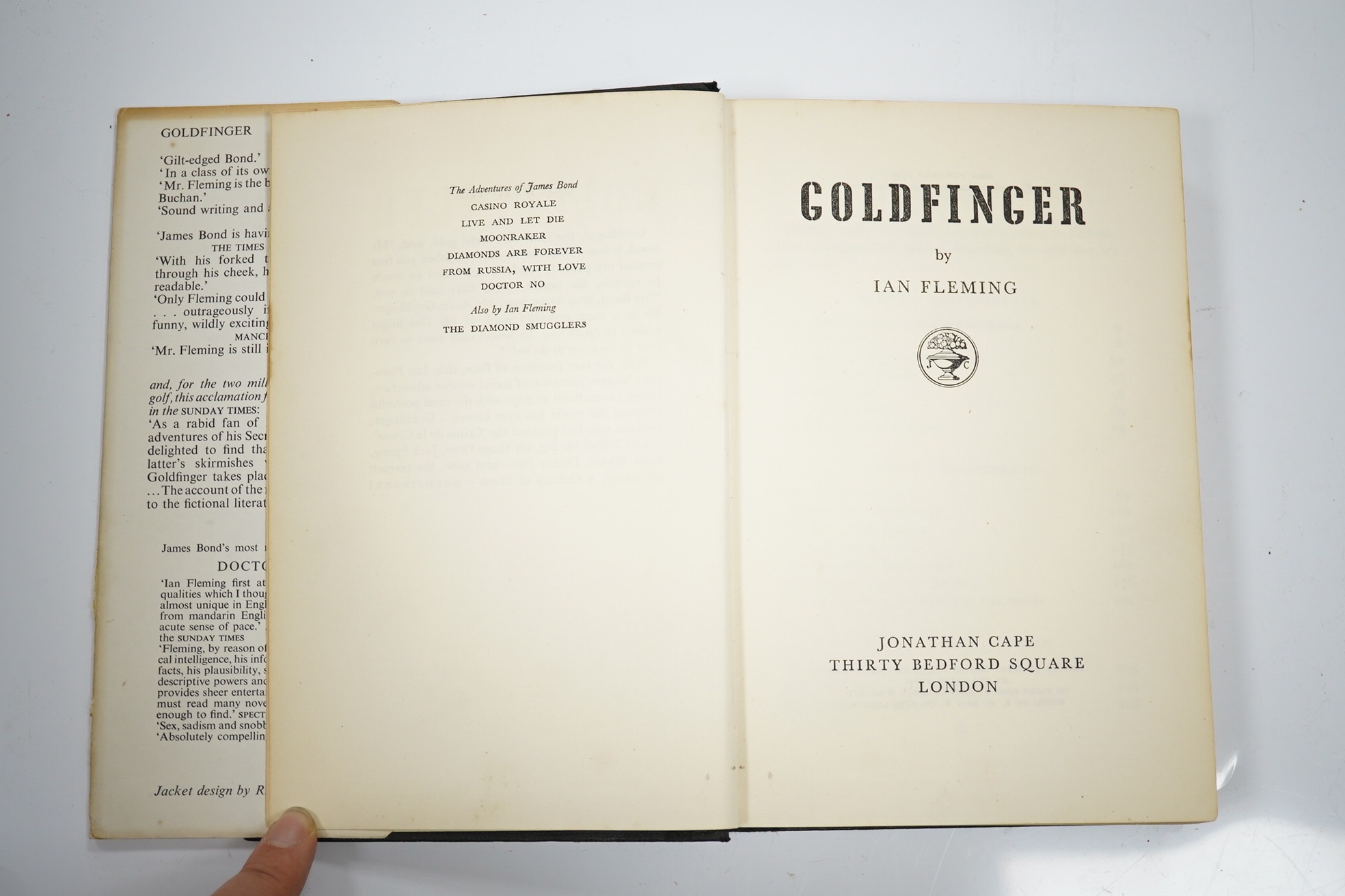 Fleming, Ian - Goldfinger. First Edition (1st impression, 2nd issue). pictorial text map, half title; publisher's black cloth, upper cover blocked in pictorial gilt and blind, d/wrapper. 1959